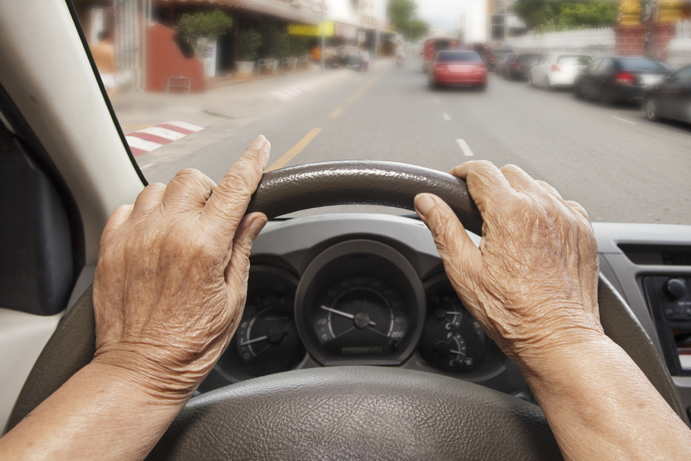 elderly person driving a car