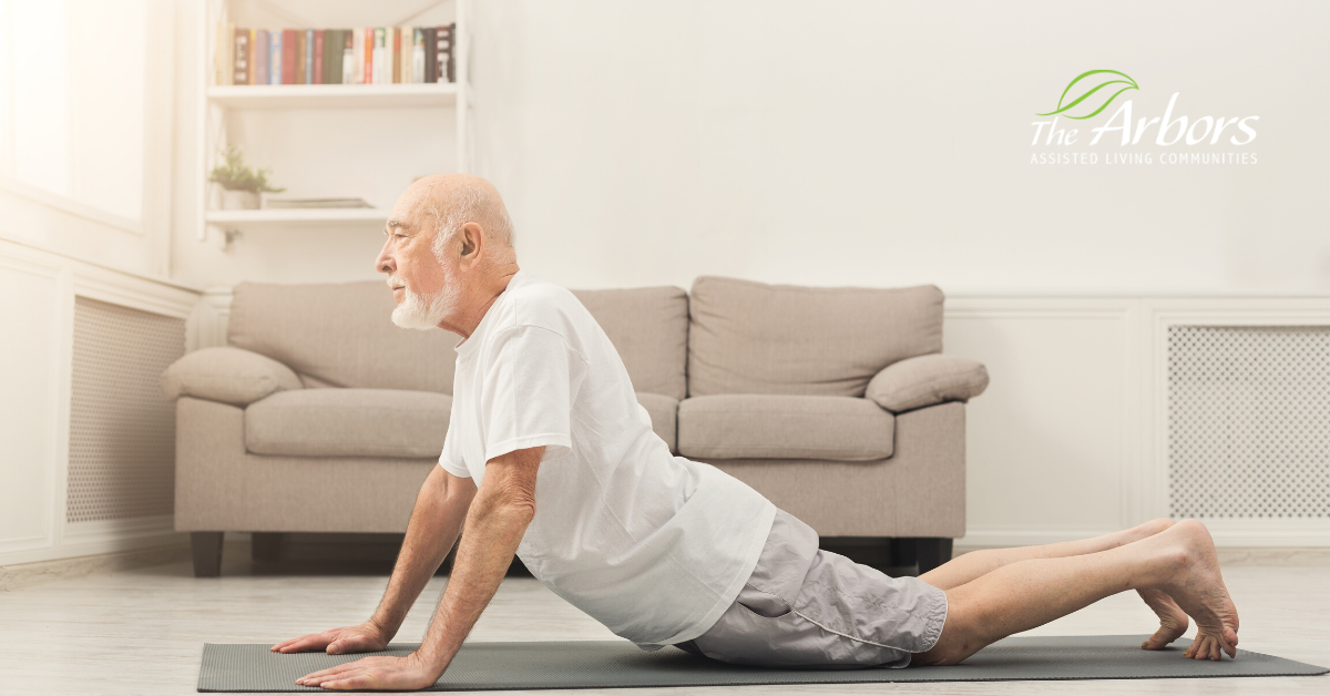 senior man doing yoga post in living room