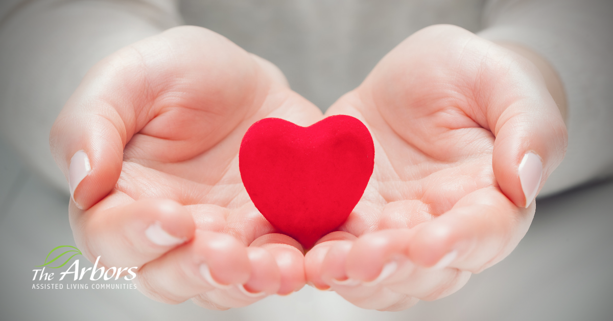 holding an image of a heart in hands